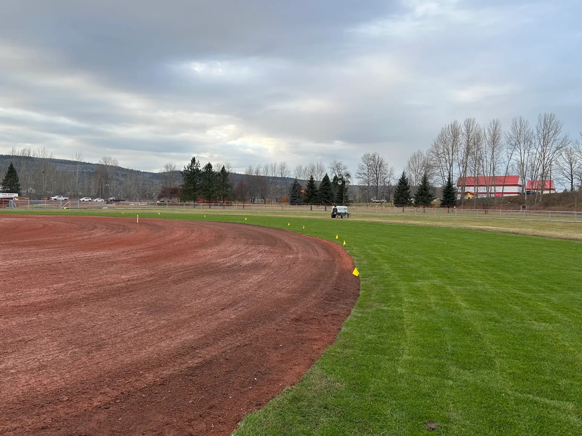 Completed ball field with red shale warning track and new turf