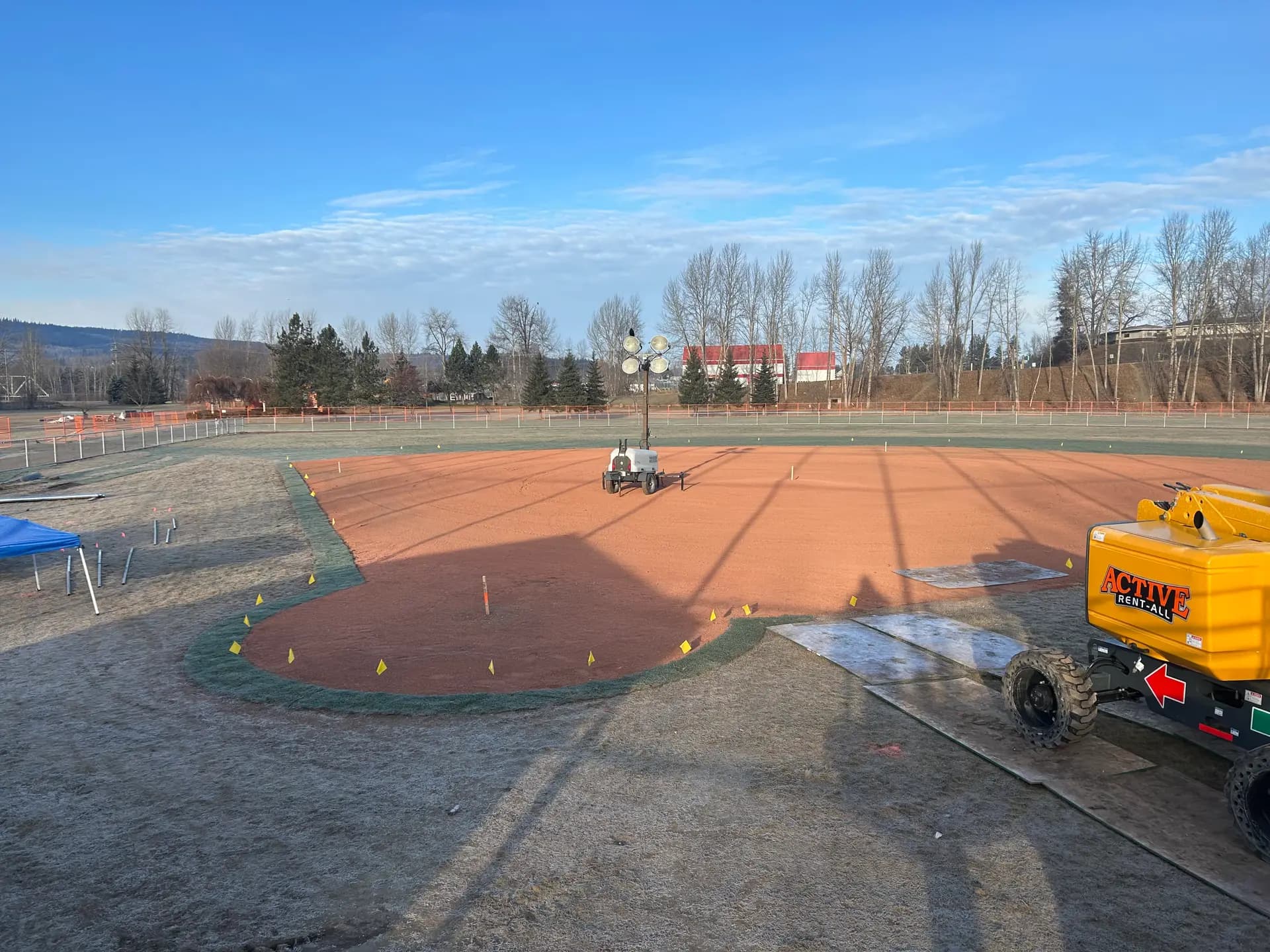 Laser grading equipment fine-grading a ball diamond infield