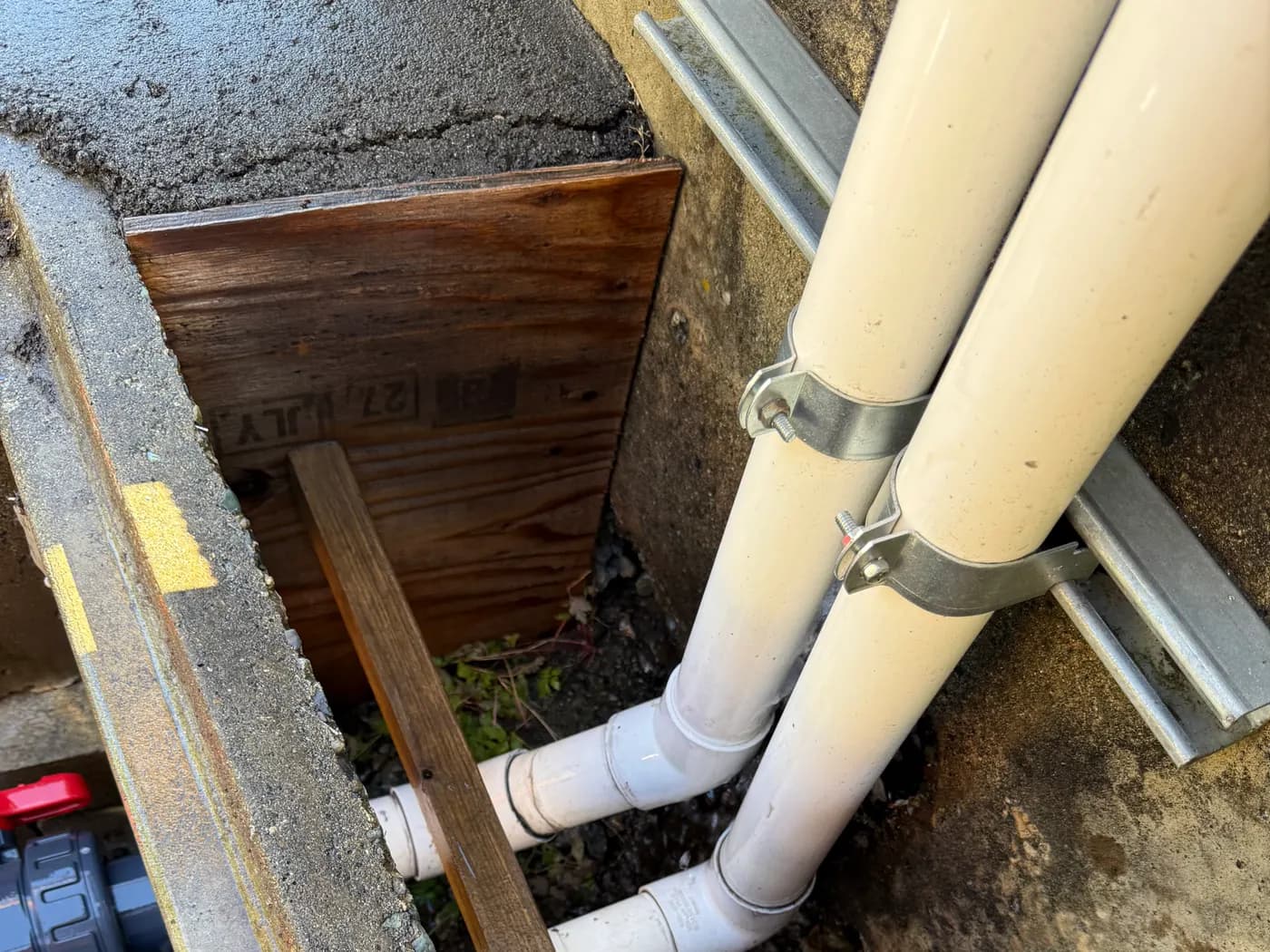 New PVC watermain piping and valves installed in a shored trench during utility construction