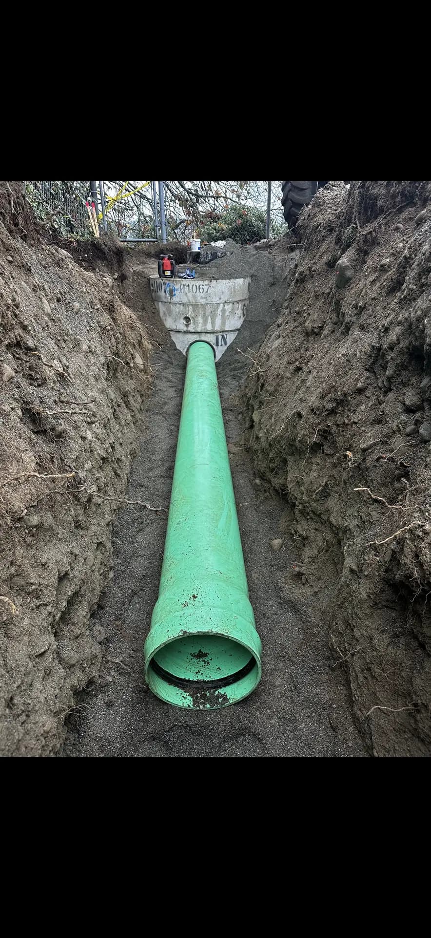 Sewer main laid on gravel bedding in a clean open trench