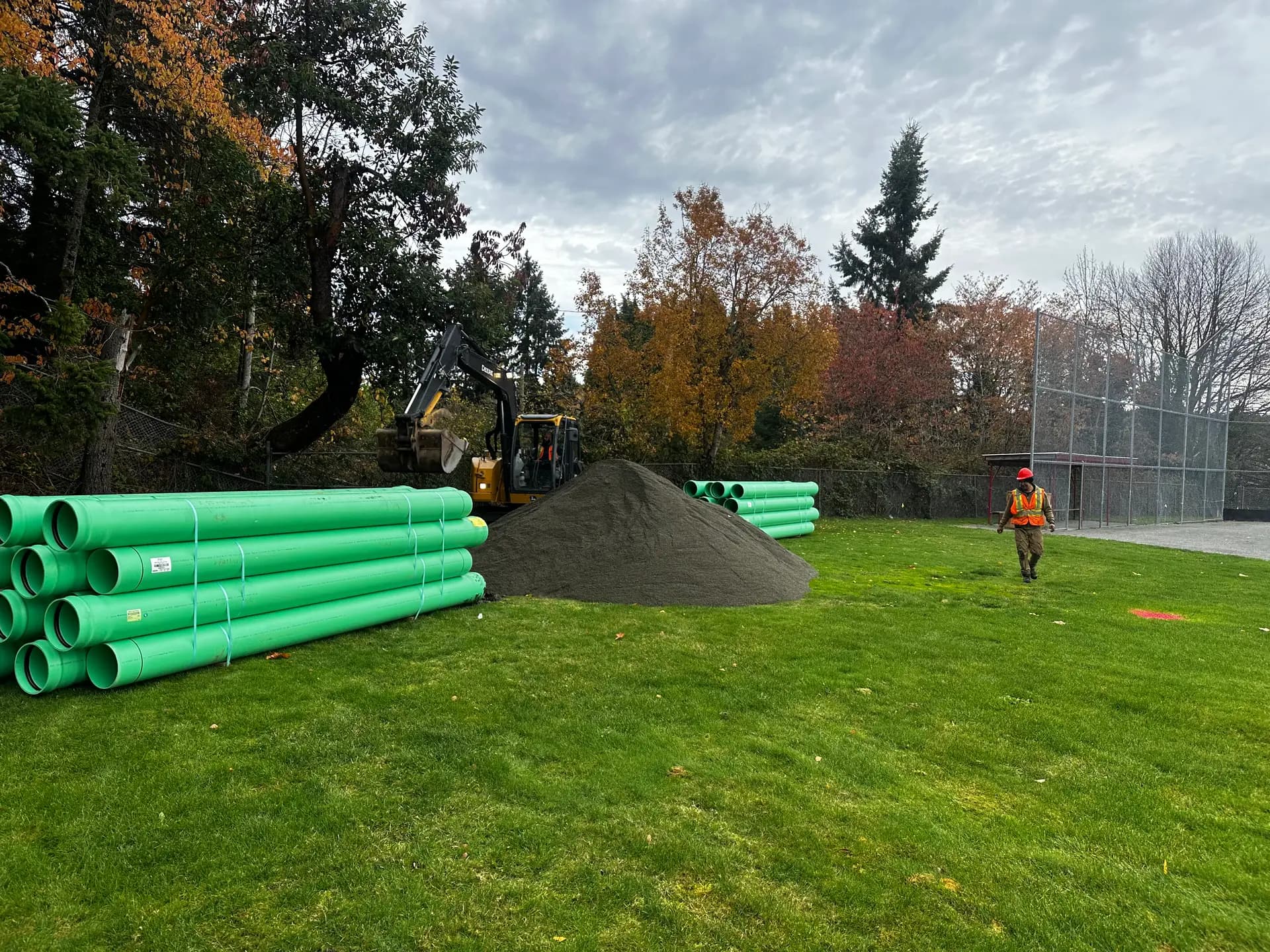 Green PVC storm sewer pipe staged on site