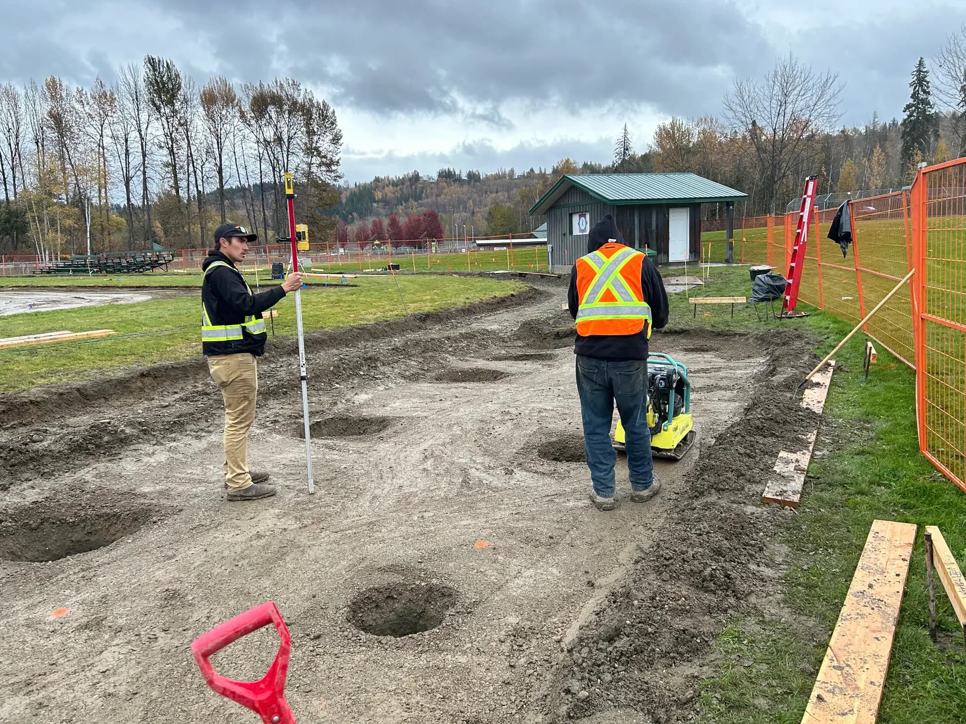 Survey and layout crew setting grade stakes