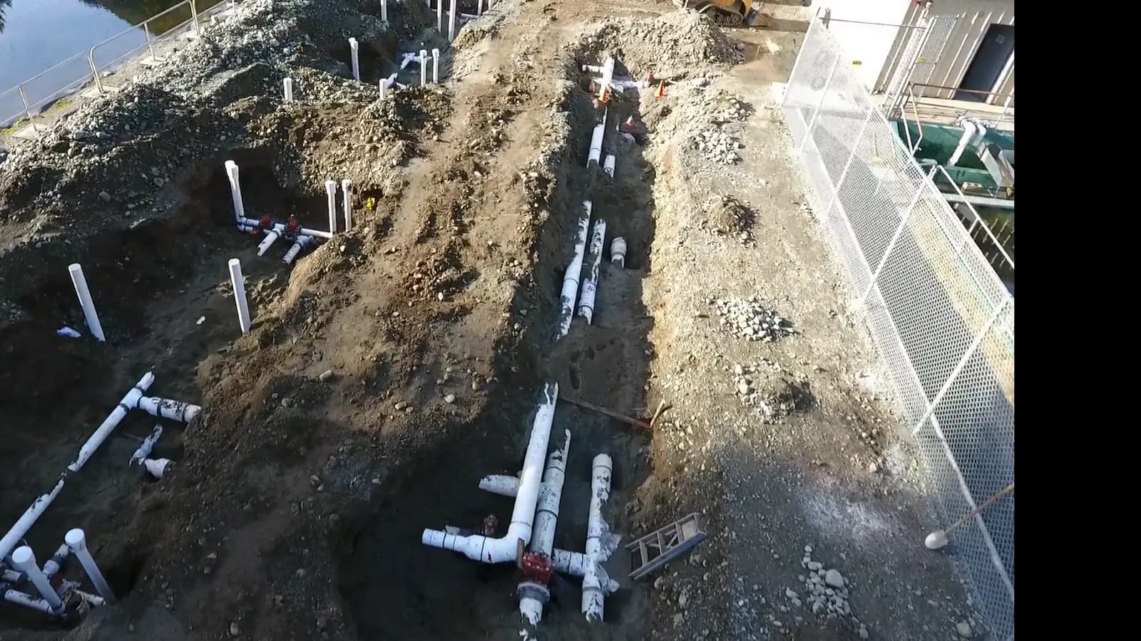 Underground utility servicing site on the BC coast with new pipe runs and service stub-ups laid out for installation